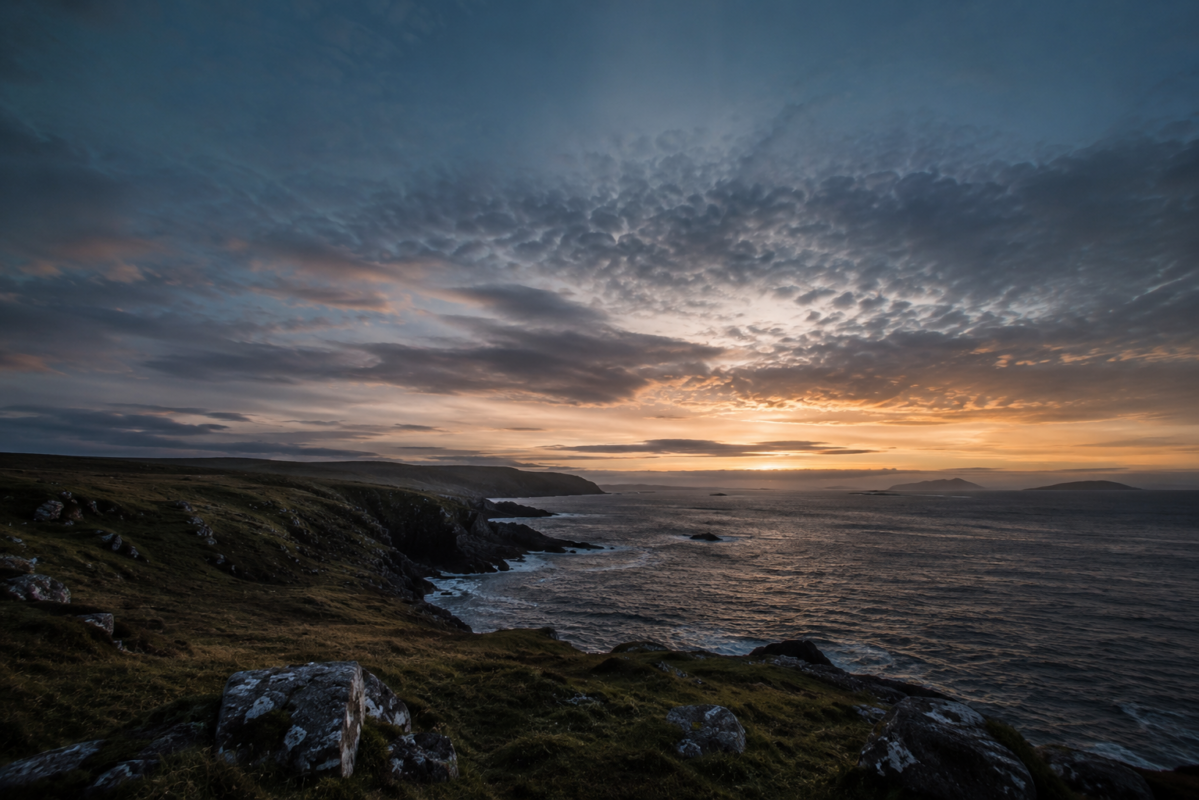 Wild coastline at dusk, sea meeting sky at the threshold of land